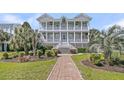 Charming two-story home with symmetrical design, double porches, and professionally landscaped front yard at 4922 Sound View Dr, Mount Pleasant, SC 29466
