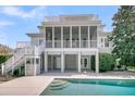 Back of house with inviting private pool and screened porch for outdoor living at 4922 Sound View Dr, Mount Pleasant, SC 29466