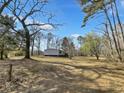 A home in a wooded lot surrounded by mature trees and a large yard at 532 Finlay Ln, Cottageville, SC 29435