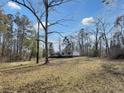 A home in a wooded lot surrounded by mature trees and a large yard at 532 Finlay Ln, Cottageville, SC 29435