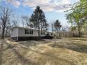 Charming home featuring gray siding, black shutters and trim, and wooden stairs at 532 Finlay Ln, Cottageville, SC 29435