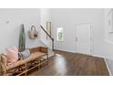 Bright entryway with hardwood floors, a cozy bench, and a view of the staircase at 579 Red Monarch Way, Moncks Corner, SC 29461