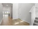 Bright hallway featuring hardwood floors, white walls, and access to other rooms in the house at 588 Red Monarch Way, Moncks Corner, SC 29461