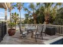 Outdoor deck with a table and chairs, perfect for relaxing and enjoying the island view at 707 Ocean Blvd, Isle of Palms, SC 29451