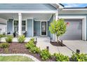 Inviting front porch with seating, landscaping, and a well-maintained exterior at 733 Spring Highlands Dr, Summerville, SC 29486