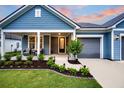 Inviting front porch with seating, detailed landscaping, and a well-maintained exterior at 733 Spring Highlands Dr, Summerville, SC 29486