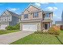 Charming two-story home featuring a two-car garage, manicured lawn, and a welcoming facade at 787 Redbud Ln, Summerville, SC 29486