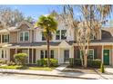 Charming townhome featuring manicured landscaping, a quaint front yard, and a welcoming entryway at 8147 Shadow Oak Dr, North Charleston, SC 29406