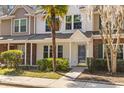 Charming townhome featuring manicured landscaping, a quaint front yard, and a welcoming entryway at 8147 Shadow Oak Dr, North Charleston, SC 29406