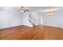 Bright living room with hardwood floors, ceiling fan, and a staircase leading to the upper level at 8147 Shadow Oak Dr, North Charleston, SC 29406