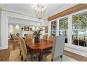 Bright dining room features a chandelier, a large window, and seamless access to the living room at 1 Vendue Range # D, Charleston, SC 29401