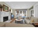 Inviting living room boasts a fireplace, plush seating, and a view of the water at 1 Vendue Range # D, Charleston, SC 29401