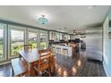 Eat-in kitchen featuring stainless steel appliances, tile floors, and an adjacent dining space with large windows at 1039 Grand Concourse St, Charleston, SC 29412