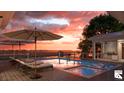A luxurious pool and lounge area are highlighted in a sunset scene with marsh views at 1077 Ship Builder St, Charleston, SC 29492