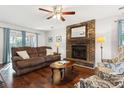 Comfortable living room with a brick fireplace, hardwood floors, and natural light at 115 Laurel Ridge Rd, North Charleston, SC 29418