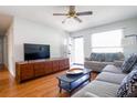 Comfortable living room features hardwood floors, a ceiling fan, and access to the front door at 117 Loblolly Ln, Summerville, SC 29483