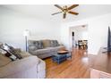 Bright living room features hardwood floors, a ceiling fan, and neutral-toned furniture at 117 Loblolly Ln, Summerville, SC 29483