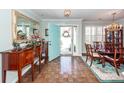 Elegant foyer featuring hardwood floors, dining area with a chandelier, and a brightly colored front door at 1233 Bridgeport Dr, Mount Pleasant, SC 29466
