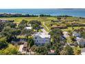 Expansive aerial view showing the home's proximity to green spaces, waterfront, and a historic fort at 1302 Middle St, Sullivans Island, SC 29482