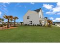 Expansive backyard with lush lawn and manicured landscaping provides ample space for outdoor activities at 1530 Homecoming Blvd, Ravenel, SC 29470