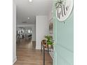 Inviting entryway with modern decor, stylish console table, and a glimpse into the open-concept living spaces at 1530 Homecoming Blvd, Ravenel, SC 29470