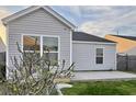 View of home's back exterior showing vinyl siding, lawn and concrete patio at 155 Tyger St, Summerville, SC 29485