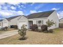 Single-story home with tidy landscaping, concrete driveway and attached one car garage at 155 Tyger St, Summerville, SC 29485