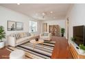 Bright living room with modern decor, hardwood floors, a ceiling fan, and neutral paint, creating a welcoming atmosphere at 1637 Tatum St, Charleston, SC 29412
