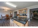 Kitchen island with granite countertop; view into dining area at 165 Infinity Dr, Dorchester, SC 29437