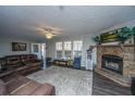 Inviting living room with a stone fireplace, plush leather furniture, and ample natural light at 165 Infinity Dr, Dorchester, SC 29437