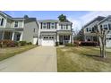 Inviting two-story home with a well-manicured lawn and cozy front porch, nestled in a suburban neighborhood at 1800 Poplar Grove Pl, Summerville, SC 29483