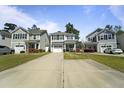 Attractive two-story home with well-maintained lawn and driveway, nestled in a quiet neighborhood setting at 1800 Poplar Grove Pl, Summerville, SC 29483