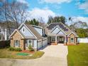 Beautiful two-story home featuring stone accents, three-car garage, solar panels and well-manicured lawn at 1874 Rifle Range Rd, Mount Pleasant, SC 29464