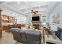 Inviting living room boasting coffered ceilings, stone fireplace and open layout to kitchen and dining at 1874 Rifle Range Rd, Mount Pleasant, SC 29464