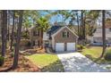Charming brick home with a manicured lawn, lush landscaping, and a convenient two-car garage at 188 Bamert St, Summerville, SC 29483