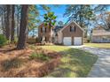 Beautiful brick home surrounded by mature trees and lush landscaping with a two-car garage and long driveway at 188 Bamert St, Summerville, SC 29483