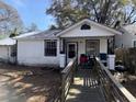 Exterior of a one-story house with a ramp and front porch with chairs and a grill at 1907 Helm Ave, North Charleston, SC 29405