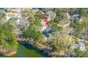 An aerial view of a lovely home surrounded by lush greenery and a serene pond at 1908 Hall Point Rd, Mount Pleasant, SC 29466