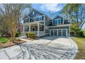Attractive home featuring a well-manicured lawn and a spacious driveway leading to an attached garage at 1908 Hall Point Rd, Mount Pleasant, SC 29466