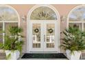 Charming front entrance featuring double doors, sidelights, and transom window at 1988 Long Creek Rd, Wadmalaw Island, SC 29487