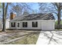 Quaint single-story home featuring a classic brick chimney, siding, and an attached one-car garage at 201 Commons Way, Goose Creek, SC 29445