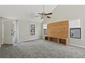 Spacious living room with vaulted ceilings, a modern ceiling fan, and a built-in wood entertainment center at 201 Commons Way, Goose Creek, SC 29445
