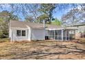 Back exterior featuring a screened in porch with neutral siding and large back yard at 202 Basswood Ave, Summerville, SC 29483