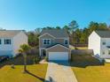 Lovely two-story home with a well-manicured lawn, curb appeal, and an attached two-car garage at 206 Cypress Plantation Rd, Moncks Corner, SC 29461