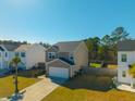 Two-story home with a well-manicured lawn, inviting curb appeal, and an attached two-car garage at 206 Cypress Plantation Rd, Moncks Corner, SC 29461