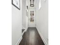 Bright hallway with dark wood floors, white walls, and natural light at 2142 Oyster Reef Ln, Mount Pleasant, SC 29466