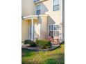 Cozy front porch with red metal chairs, potted plants, and manicured shrubs at 265 Grand Oaks Drive Dr, Ladson, SC 29456