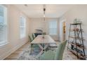 Dining room with large windows, wood table set, and rustic furnishings at 2739 Calico Bass Ln, Johns Island, SC 29455
