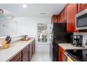 Well-lit kitchen with stainless steel appliances and cherry wood cabinets at 275 Kelsey Blvd, Charleston, SC 29492