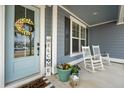 Welcoming front porch features rocking chairs, a wreath on the front door, and charming decor at 306 Long Pier St, Summerville, SC 29486